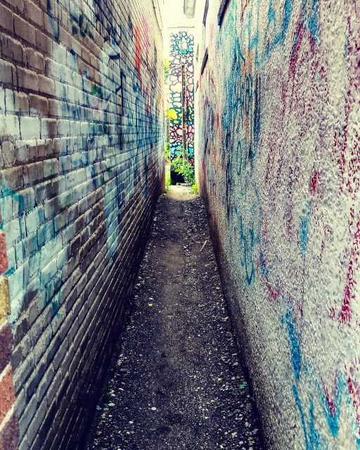 You never know what you will find in the spaces between buildings. #streetart #streetphotography